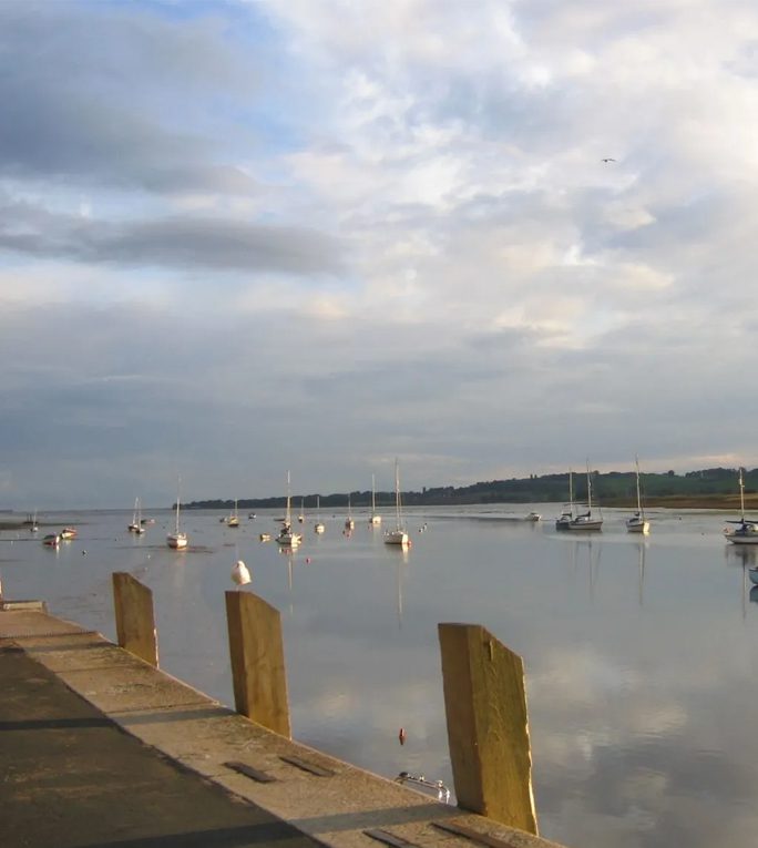 A body of water with many small boats in it.