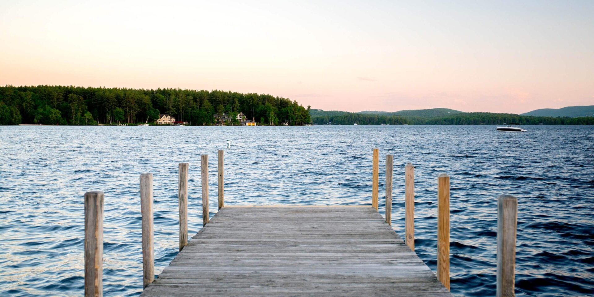 A dock with a view of the water and trees.